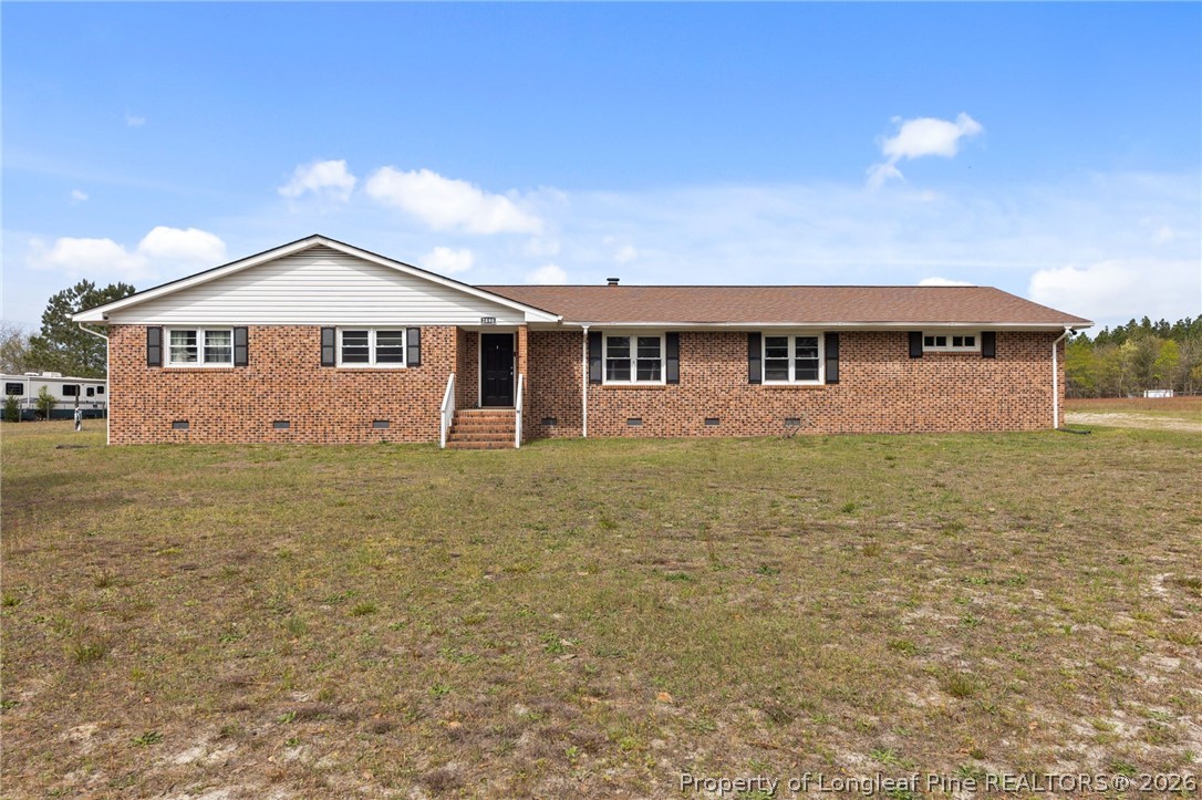 2890 Fulford McMillan Road Raeford, NC 28376 - Photo 1 of 37 a front view of house with yard and trees in the background