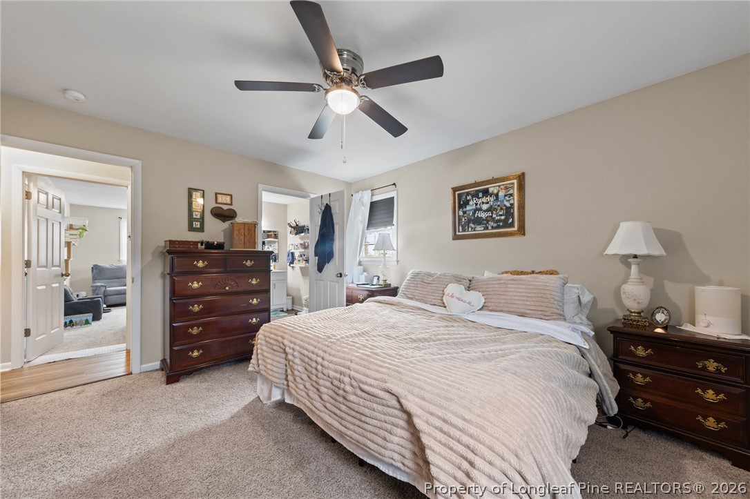 2890 Fulford McMillan Road Raeford, NC 28376 - Photo 20 of 37 a bedroom with a bed and a chandelier