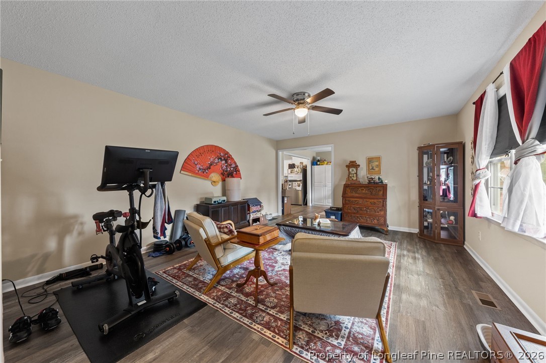 2890 Fulford McMillan Road Raeford, NC 28376 - Photo 25 of 37 a living room with furniture a rug and a flat screen tv