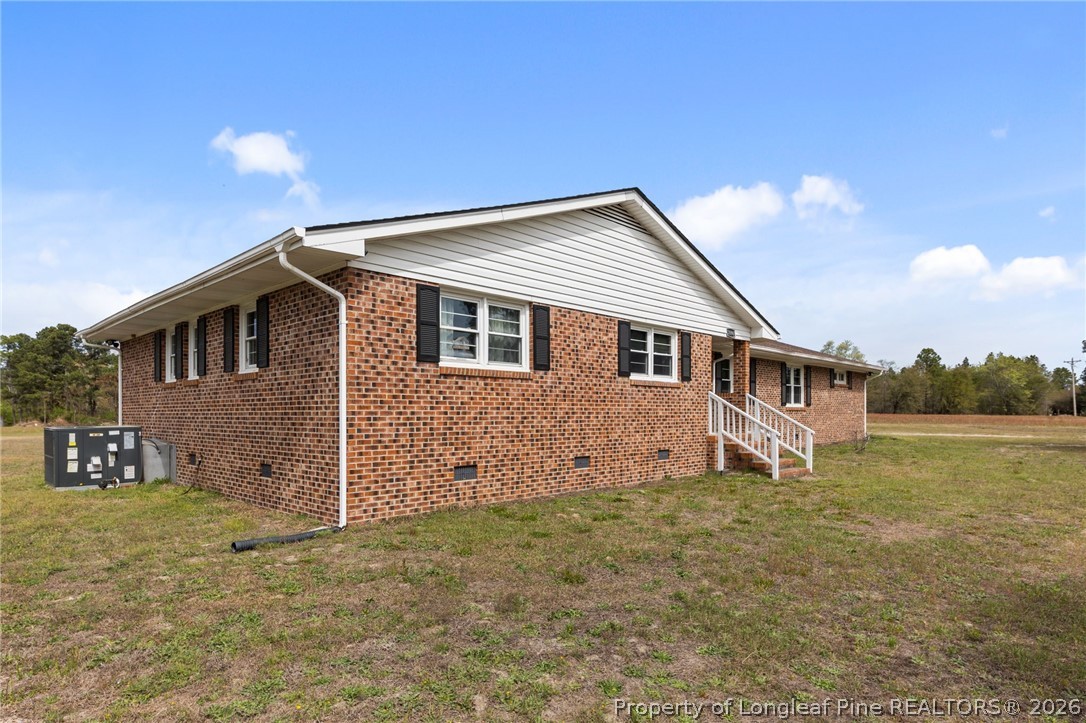 2890 Fulford McMillan Road Raeford, NC 28376 - Photo 27 of 37 a view of a house with a yard
