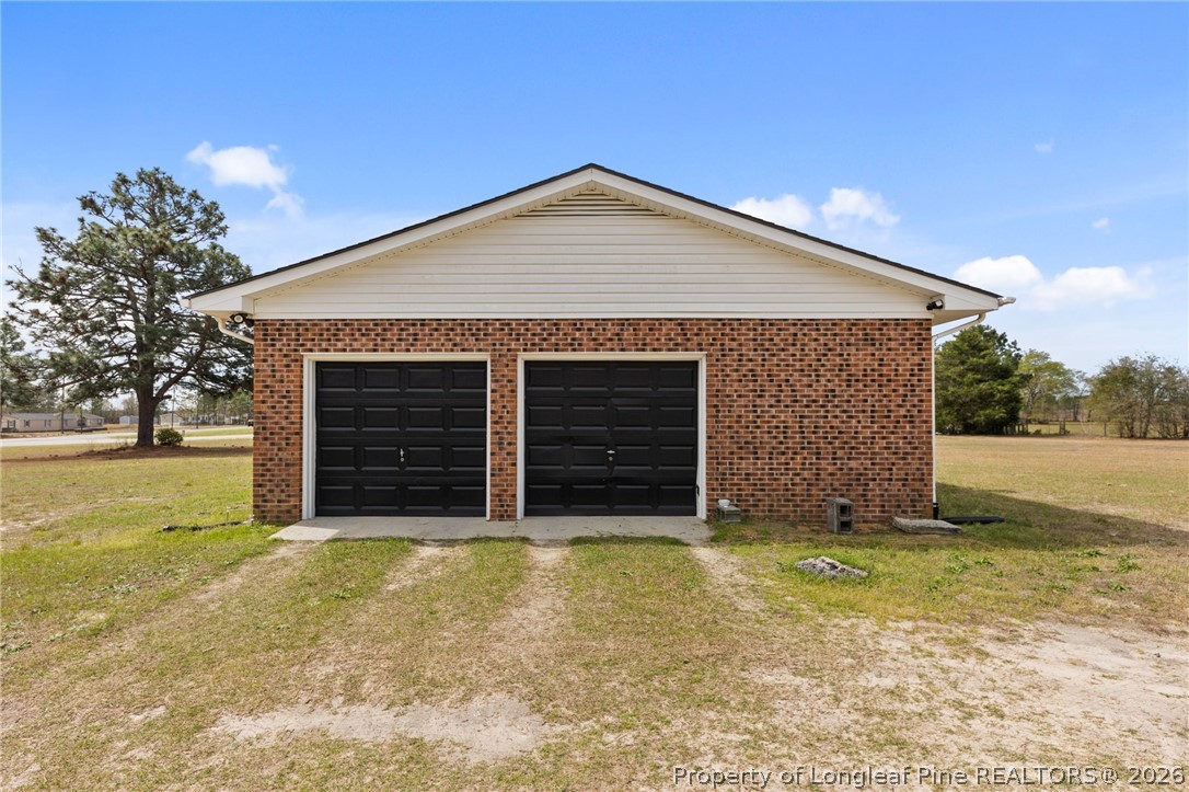 2890 Fulford McMillan Road Raeford, NC 28376 - Photo 31 of 37 a view of house with backyard and garage