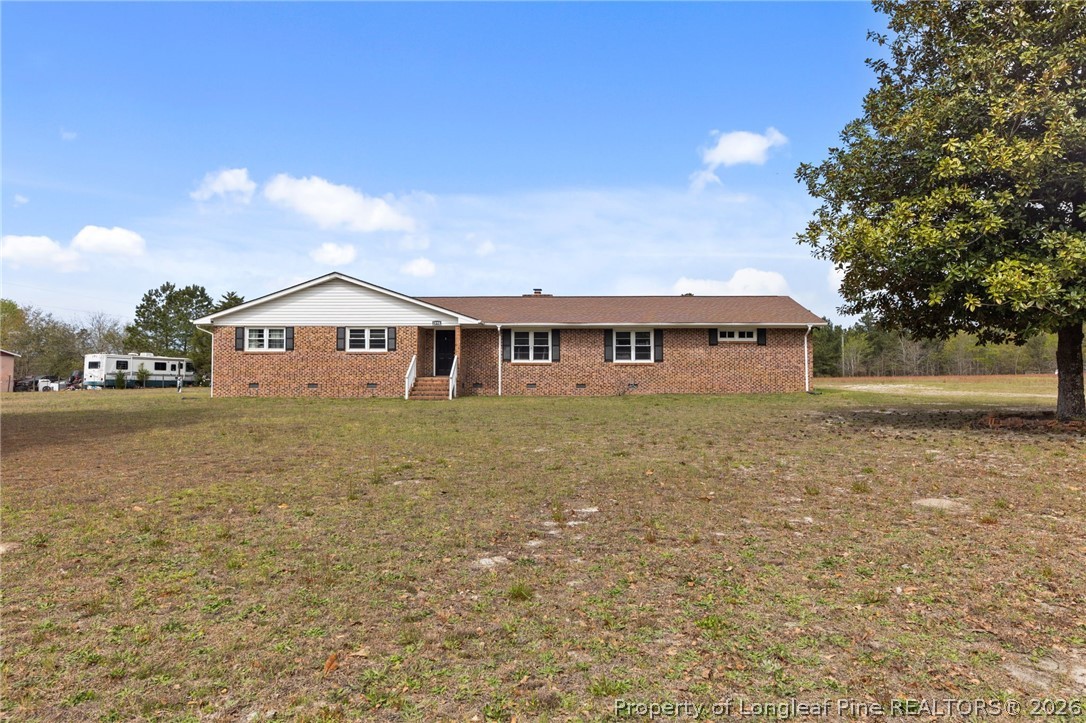 2890 Fulford McMillan Road Raeford, NC 28376 - Photo 34 of 37 a front view of a house with a yard