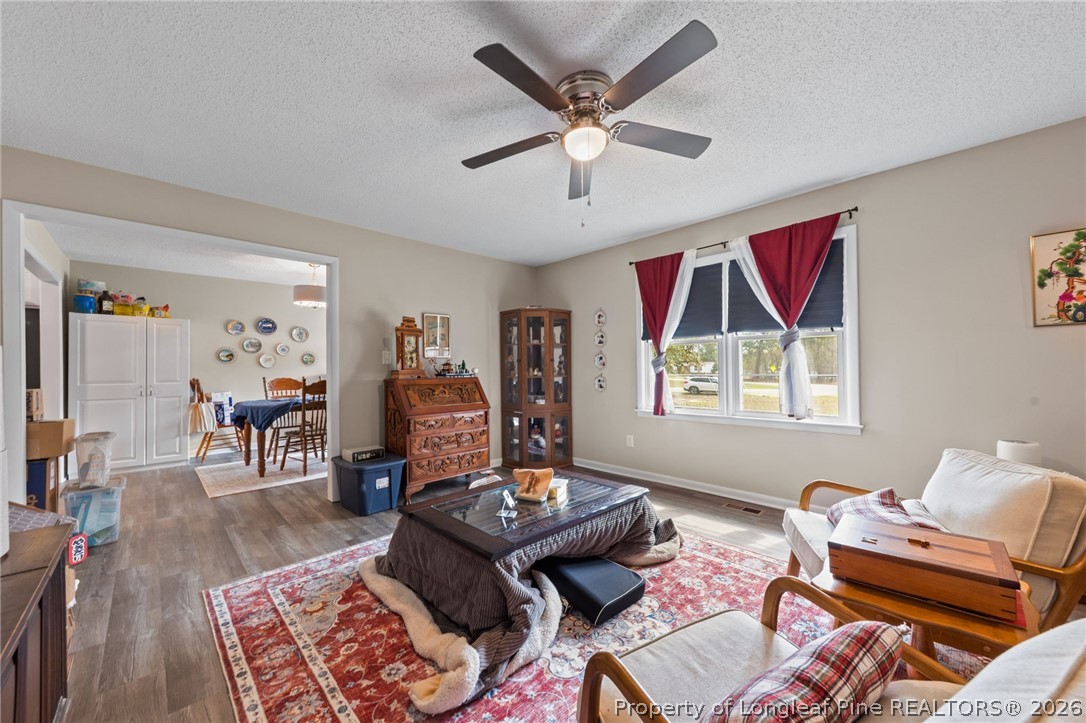 2890 Fulford McMillan Road Raeford, NC 28376 - Photo 10 of 37 a living room with furniture and wooden floor