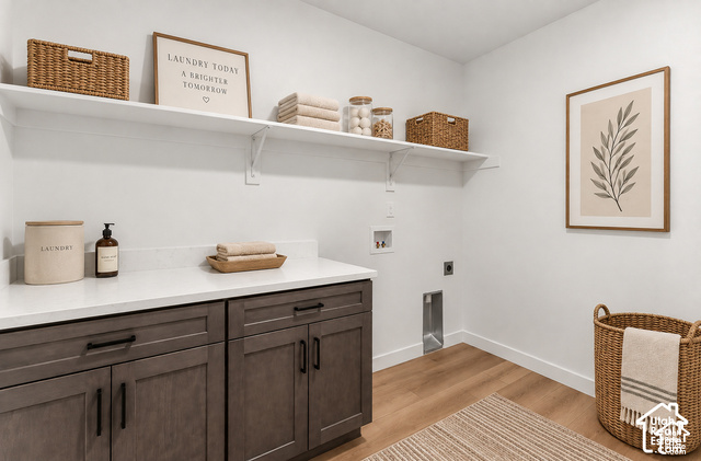 2503 North Scarlet Road, Unit 252 Eagle Mountain, UT 84005 - Photo 13 of 17 White walls, wood-finish flooring, two white floating shelves, dark wood-finish cabinetry, and a white countertop