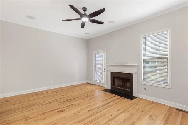 an empty room with windows a fireplace