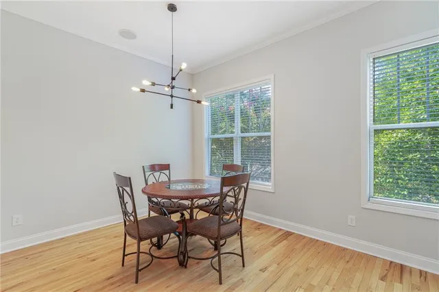 a view of a dining room with furniture window and wooden floor