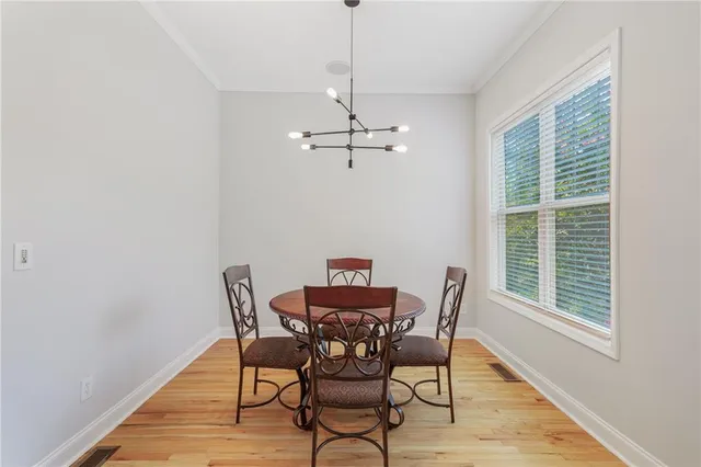 a view of a dining room with furniture window and wooden floor