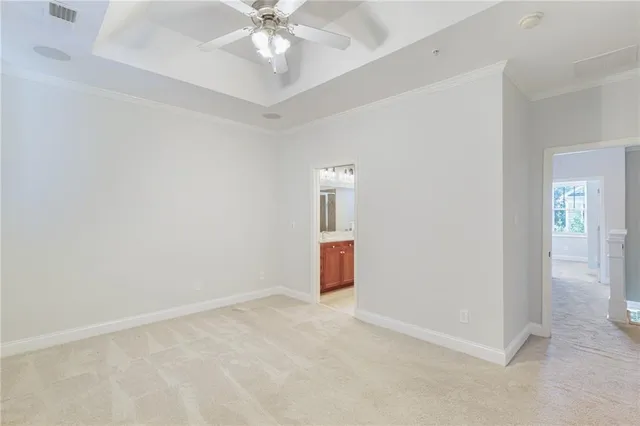an empty room with closet and a chandelier fan