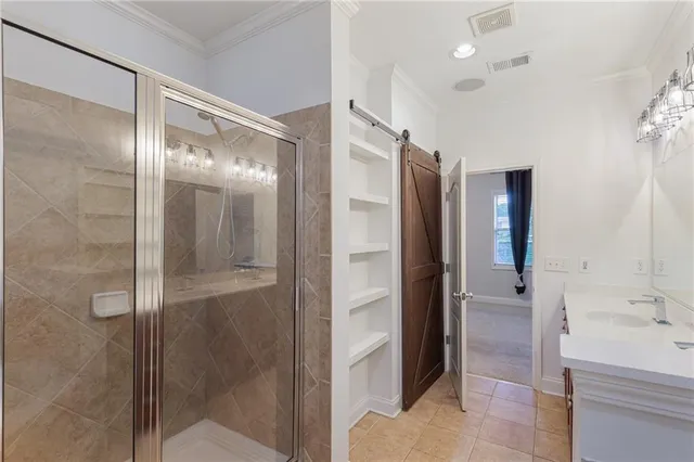 a bathroom with a glass shower door and a sink