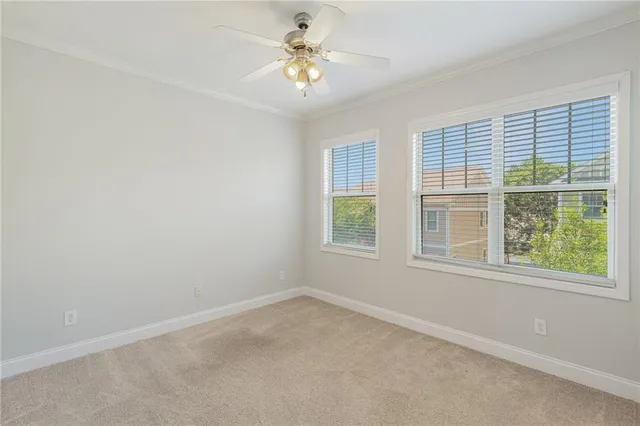 an empty room with a window and a fan