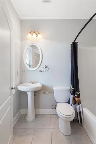 a white toilet sitting next to a bathroom sink