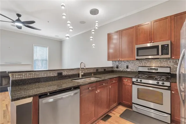 a kitchen with a sink stove and microwave