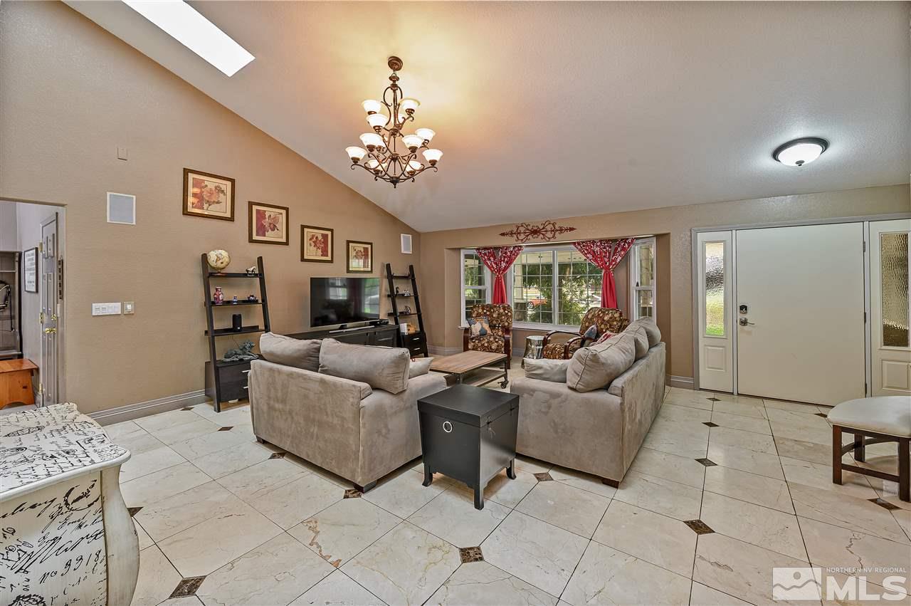 13040 Valley Springs Road Reno, NV 89511 - Photo 14 of 39 a living room with furniture and a chandelier