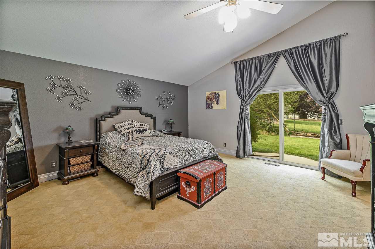 13040 Valley Springs Road Reno, NV 89511 - Photo 29 of 39 a bedroom with a bed and a view of living room
