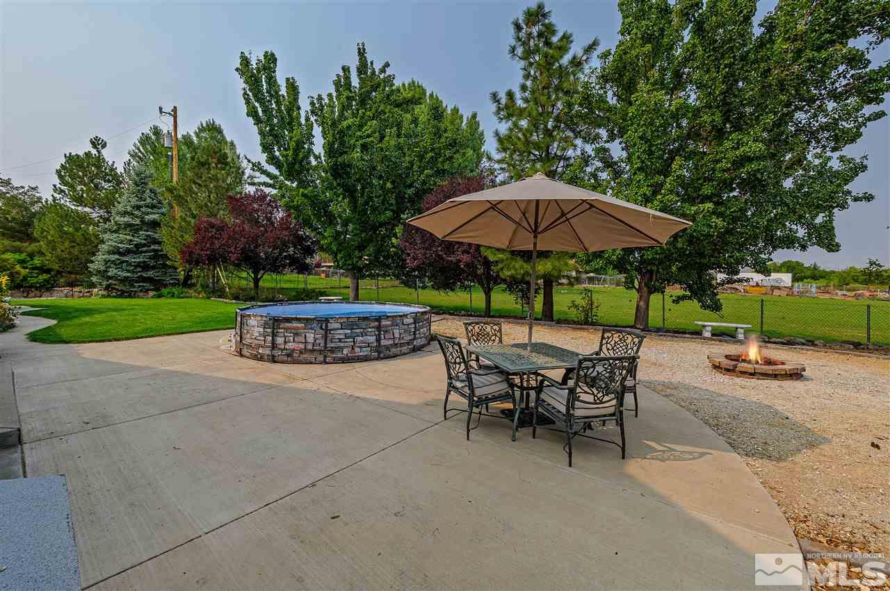 13040 Valley Springs Road Reno, NV 89511 - Photo 31 of 39 a view of patio with chairs and table under an umbrella