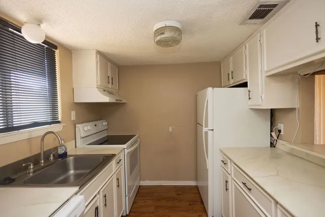a kitchen that has a sink and a stove
