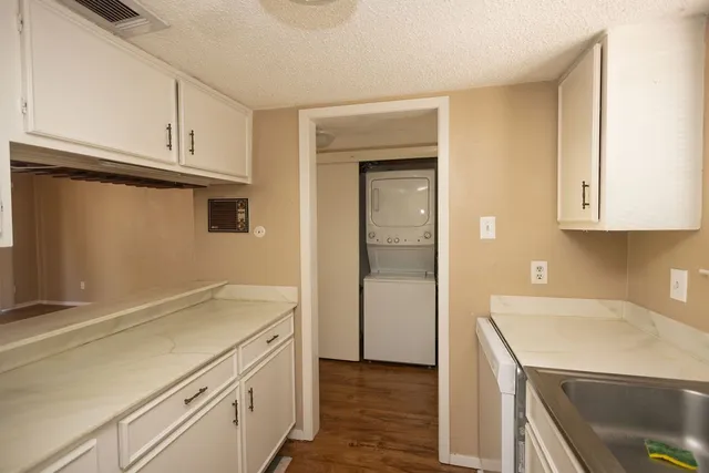 a utility room with cabinets washer and dryer