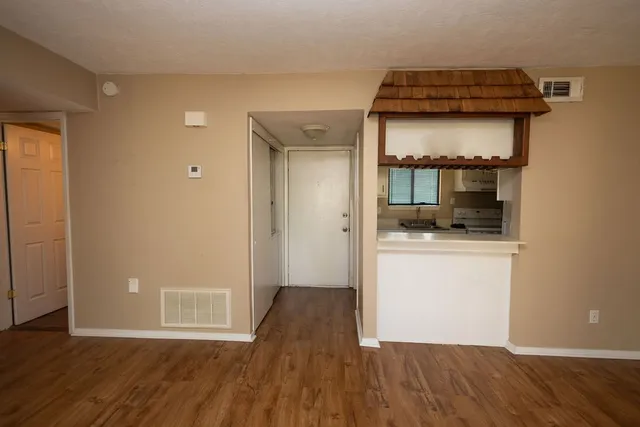 wooden floor in an empty room and a mirror