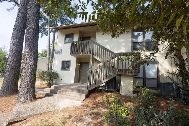 a view of a house with a yard patio and a garden