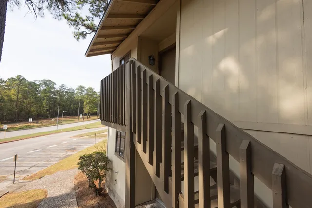a view of a pathway of a building with wooden fence
