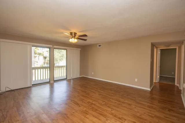 wooden floor in an empty room with a window