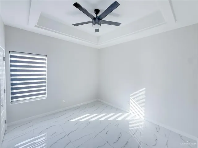 a view of empty room with ceiling fan