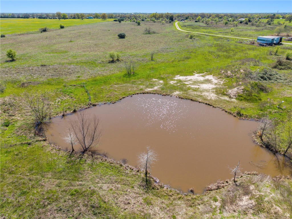 8560 Grassbur Road Bryan, TX 77808 - Photo 6 of 16 a view of a lake with a house
