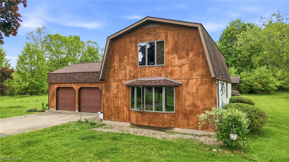 6667 Chestnut-Ridge Road Hubbard, OH 44425 - Photo 2 of 35 Gambrel-style exterior with wood-finish siding, a two-car garage, ample acreage