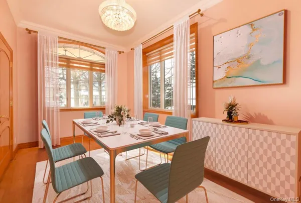 a view of a dining room with furniture a chandelier and wooden floor