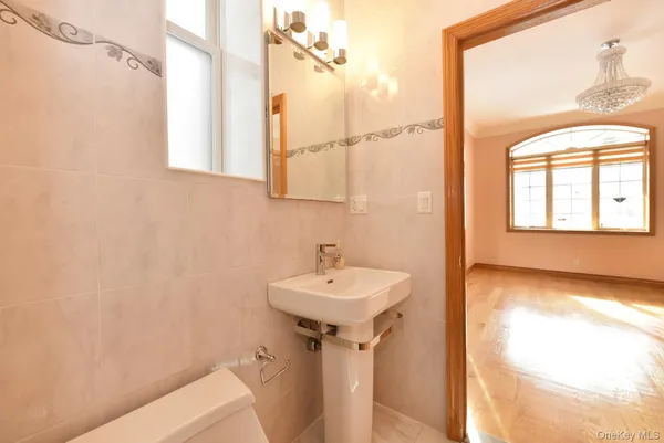 a bathroom with a sink a mirror and a window