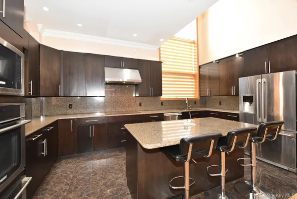 a kitchen with a stove a sink and a refrigerator