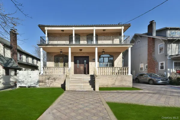 a front view of a house with a garden