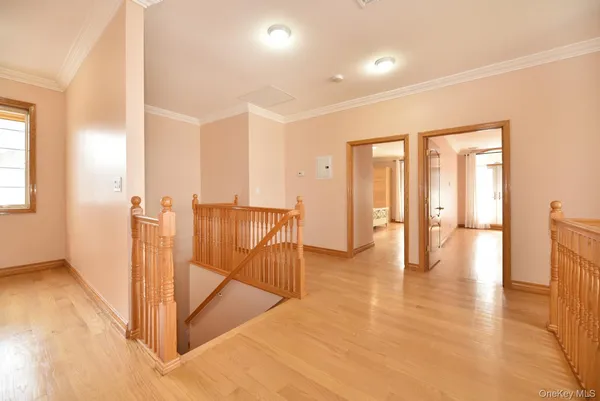 a view of a hallway with wooden floor and glass door