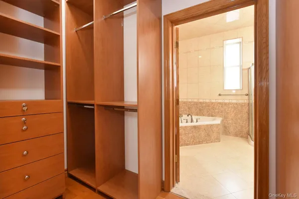 a view of walk in closet with empty racks