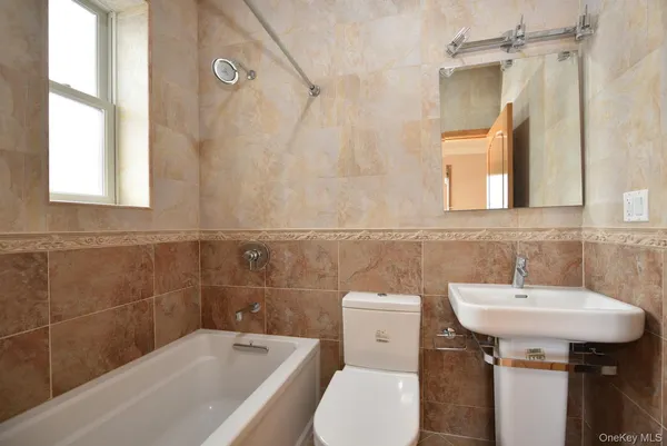 a bathroom with a sink a toilet and bathtub