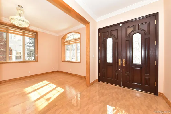 a view of empty room with windows and chandelier