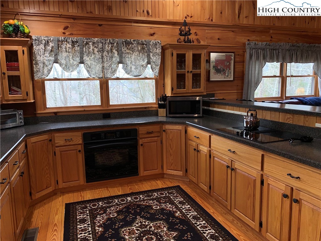 447 South Turkey Ridge Crumpler, NC 28617 - Photo 11 of 39 a kitchen with wooden cabinets and a stove top oven