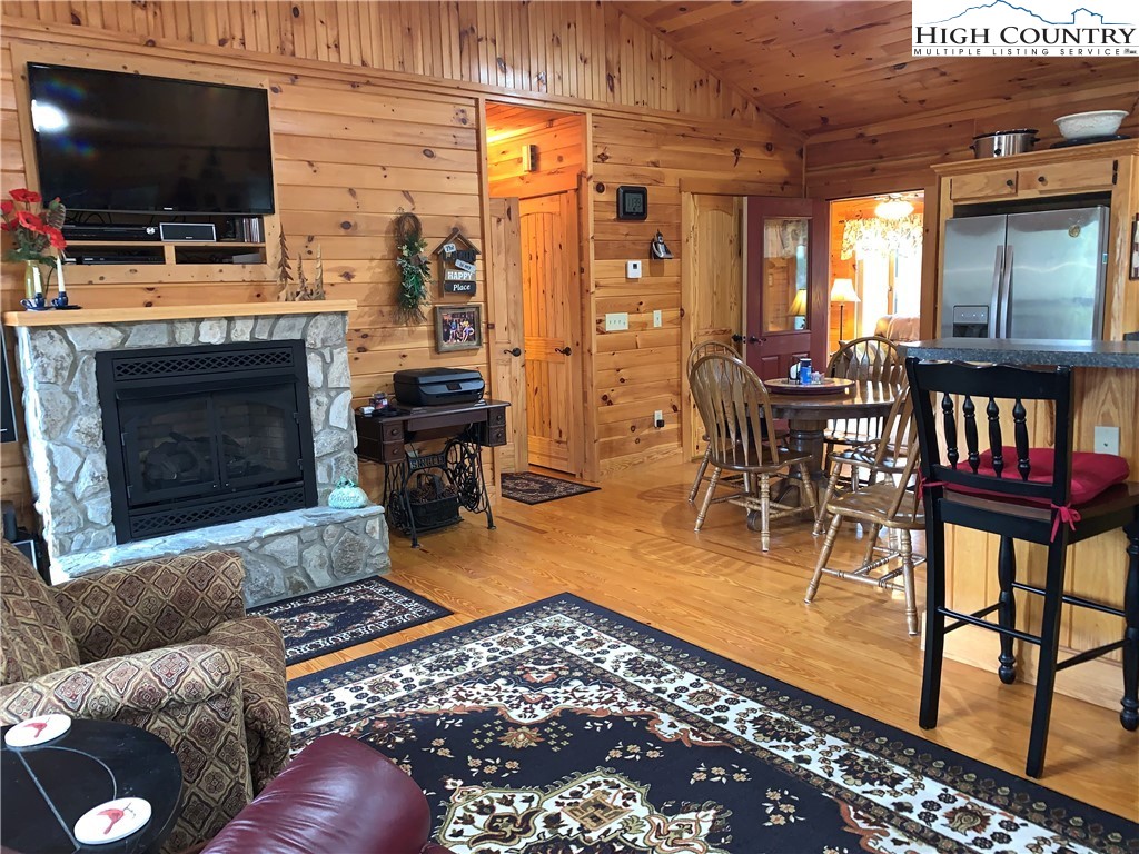 447 South Turkey Ridge Crumpler, NC 28617 - Photo 15 of 39 a living room with furniture a flat screen tv and a fireplace
