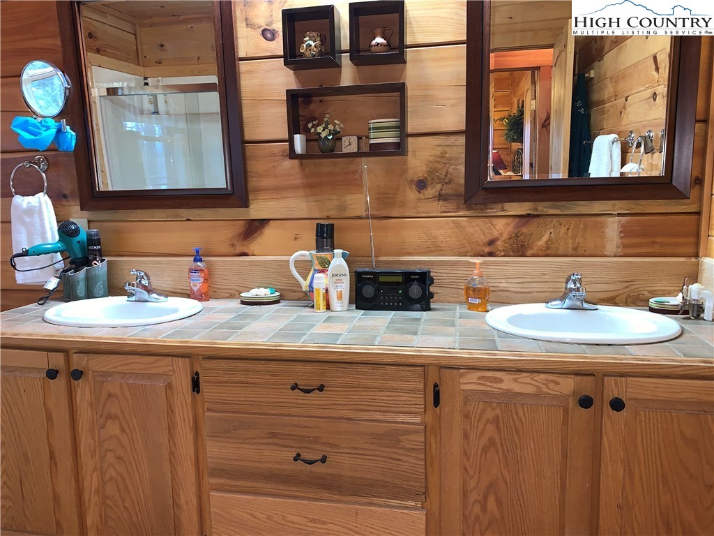 447 South Turkey Ridge Crumpler, NC 28617 - Photo 18 of 39 a bathroom with a sink and a mirror