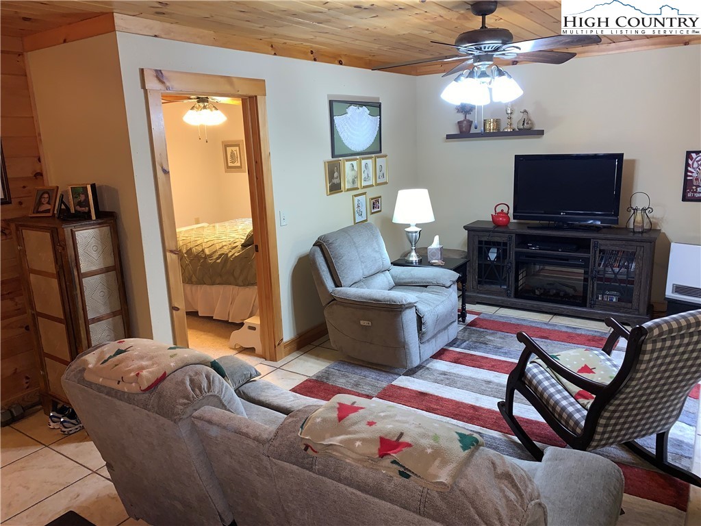 447 South Turkey Ridge Crumpler, NC 28617 - Photo 23 of 39 a bedroom with furniture and a flat screen tv