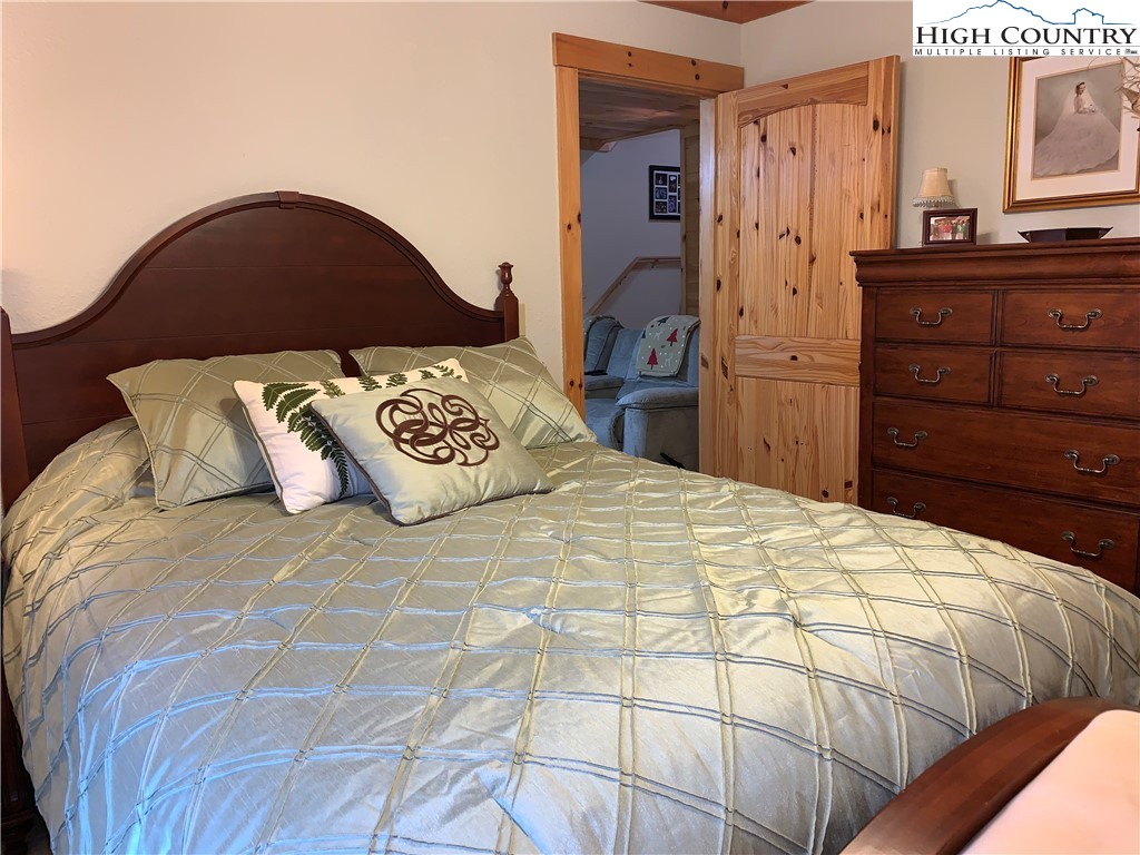 447 South Turkey Ridge Crumpler, NC 28617 - Photo 27 of 39 a bedroom with a bed and a dresser