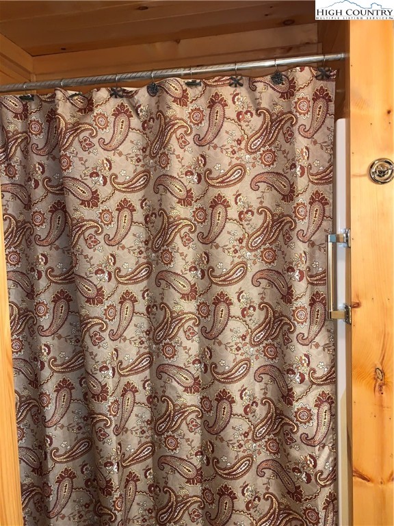 447 South Turkey Ridge Crumpler, NC 28617 - Photo 29 of 39 a bathroom with a shower curtain and a shower curtain