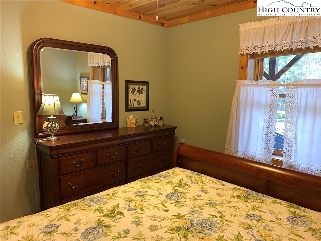 447 South Turkey Ridge Crumpler, NC 28617 - Photo 32 of 39 a room with a bed and a dresser
