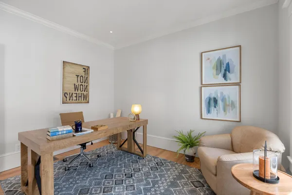 a bedroom with furniture and wooden floor