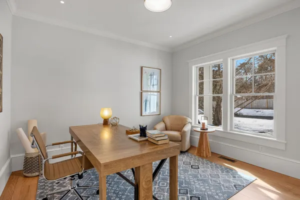 a bedroom with a bed and a lamp on the dresser