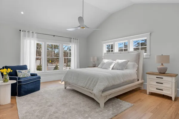 a bathroom with a granite countertop sink a mirror and a toilet