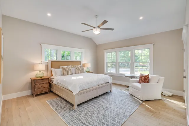 a bedroom with a large bed and a window