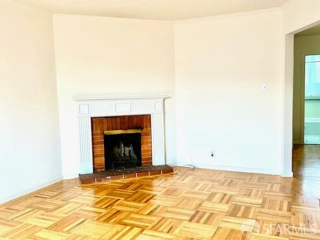 a view of an empty room with a fireplace