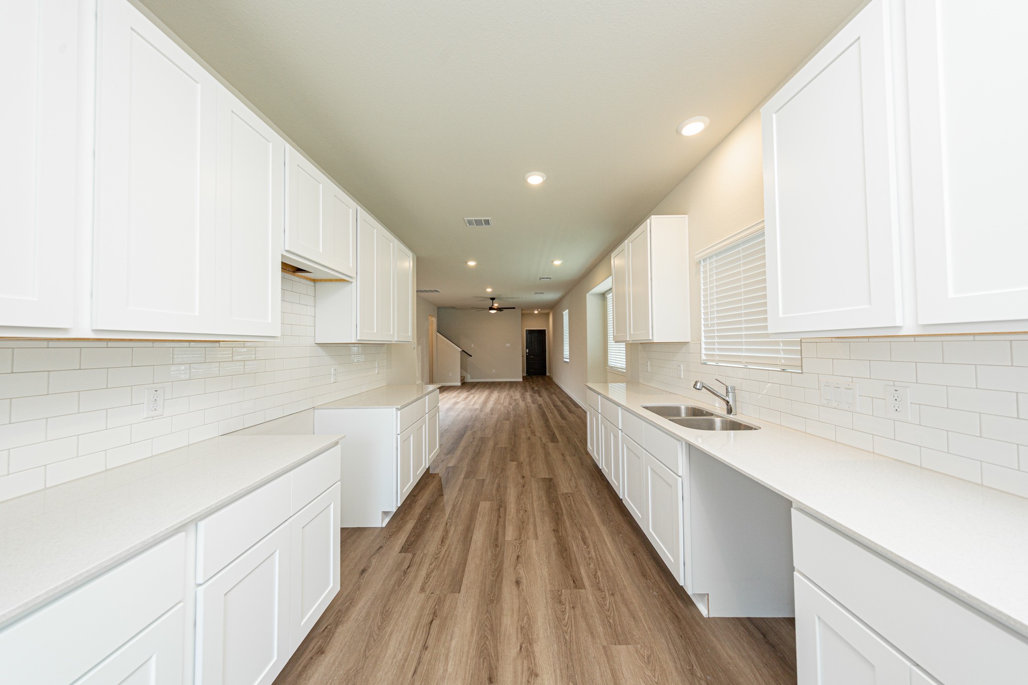 13651 Kit Run Splendora, TX 77372 - Photo 6 of 27 a large kitchen with kitchen island a large counter top space a sink stainless steel appliances and cabinets