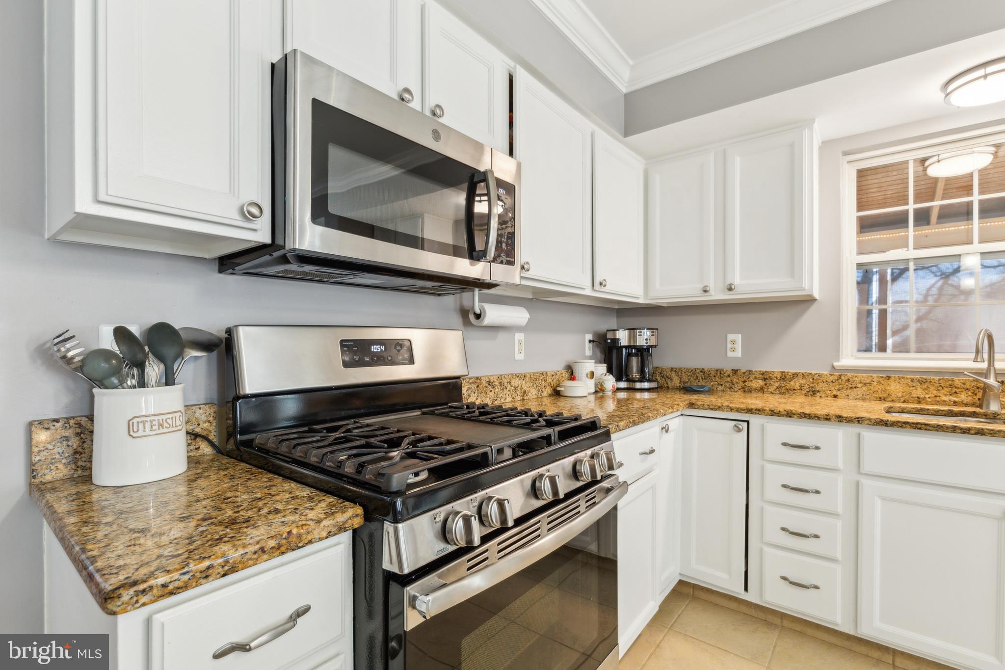 20752 Cross Timber Drive Ashburn, VA 20147 - Photo 14 of 39 a kitchen with stainless steel appliances granite countertop a stove and a microwave